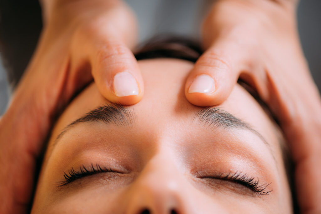 Craniosacral Therapy Massage. CST therapist Massaging of Woman’s Head.